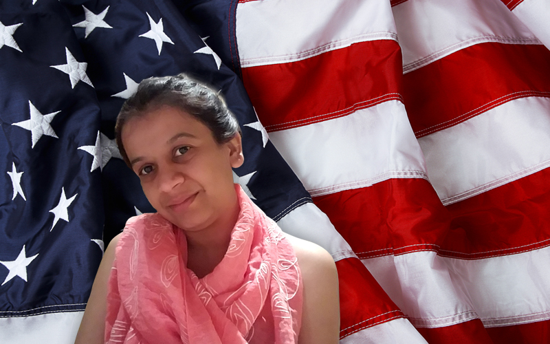 Payal Mody in front of a flag