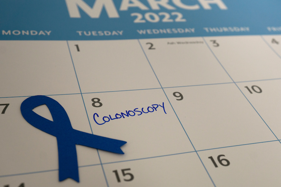 Colonoscopy scheduled on the calendar with blue ribbon for Colorectal Cancer Awareness