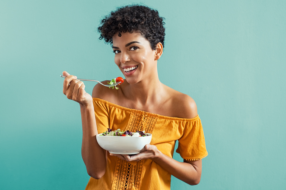 woman eating salad_The Difference Between Probiotics and Prebiotics_Dietitians On Demand