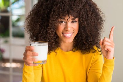 woman holding glass of milk osteoporosis