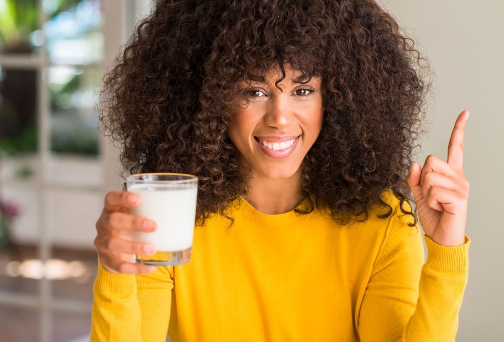 woman holding glass of milk osteoporosis