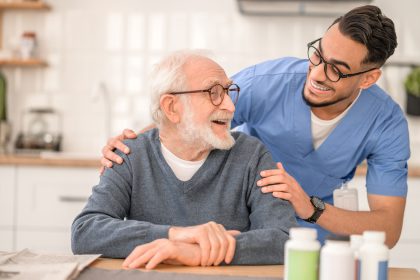 male nurse helping an older male patient
