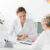 Smiling dietitian and patient with nutritional problems preparing a diet plan during a meeting