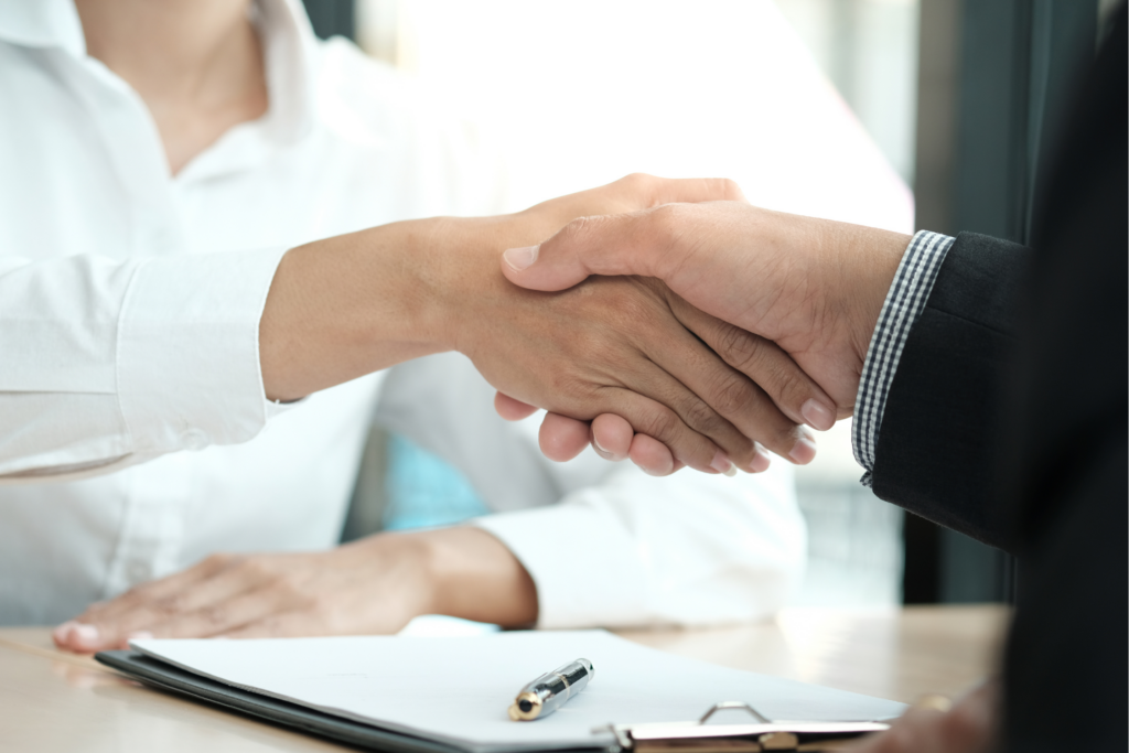 Shaking hands after partnering with a staffing agency to hire a nutrition consultant.
